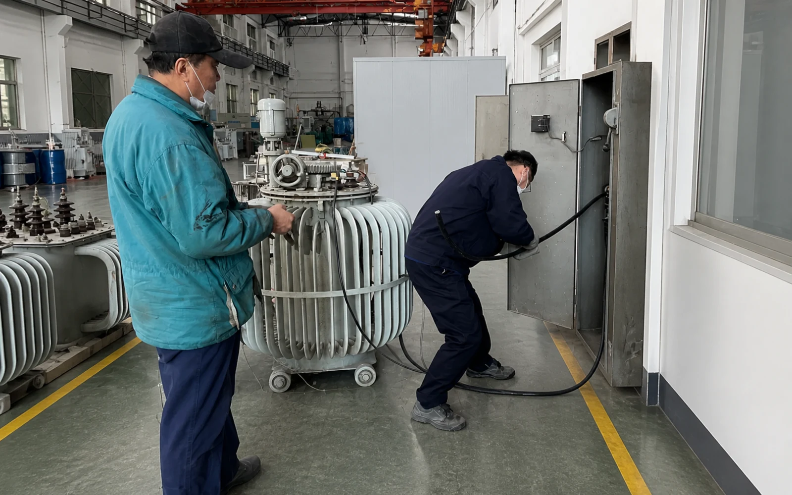 Transformer inspection and test work in a clean factory bay
