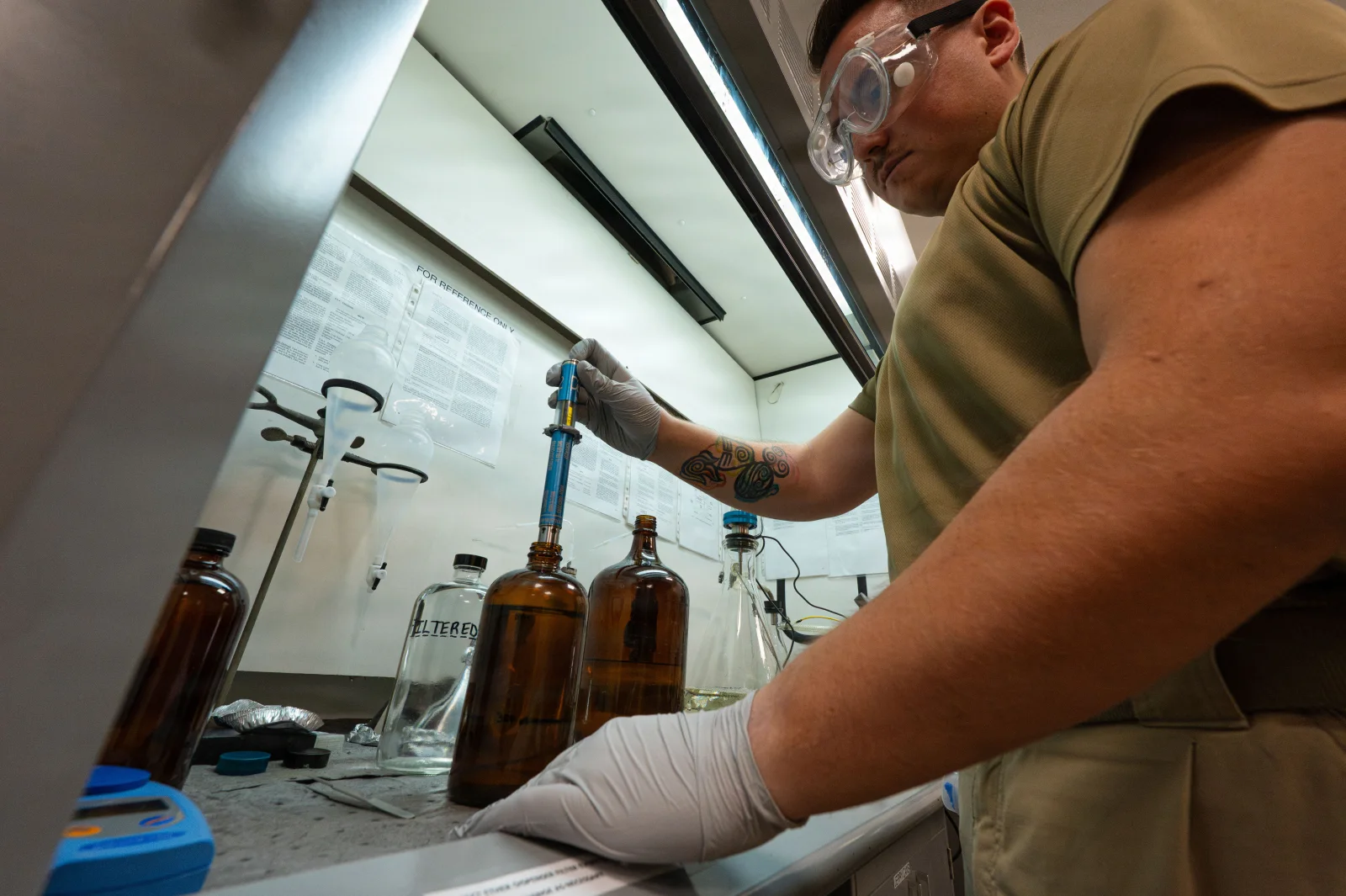 Laboratory technician performing a fuel-sample test as a process-control illustration